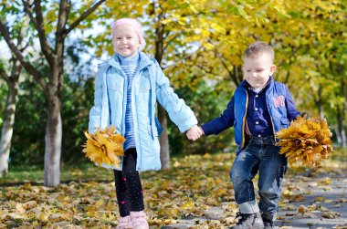 Young children skipping hand in hand