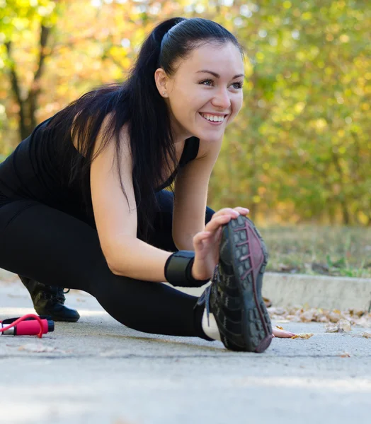 Glad kvinna utövar i en park — Stockfoto