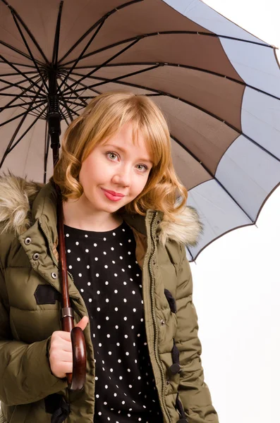 Attractive woman sheltering under an umbrella — Stock Photo, Image