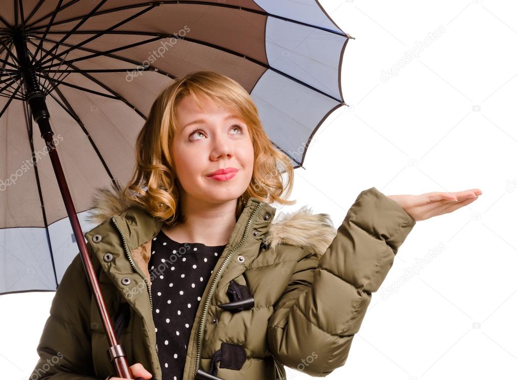 Smiling woman holding out her hand for rain