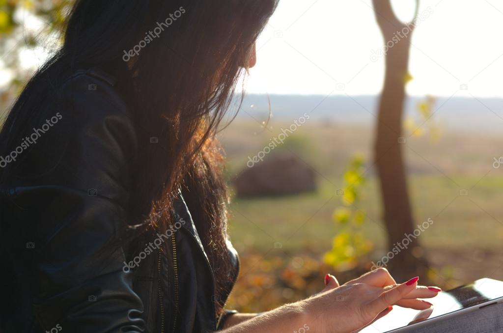 Side view of a woman using a tablet
