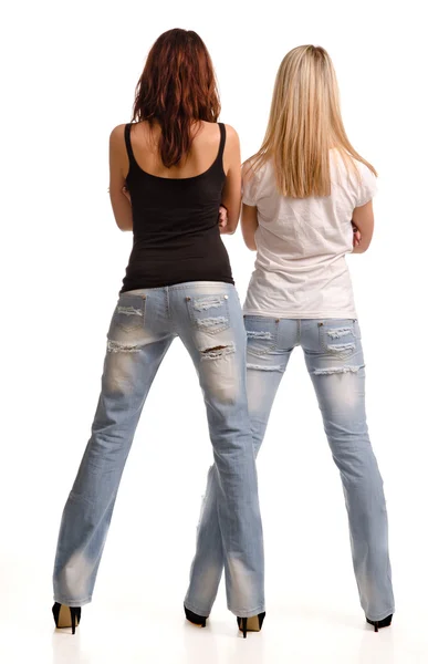 Rear view of two girls in tight fitting jeans — Stock Photo, Image