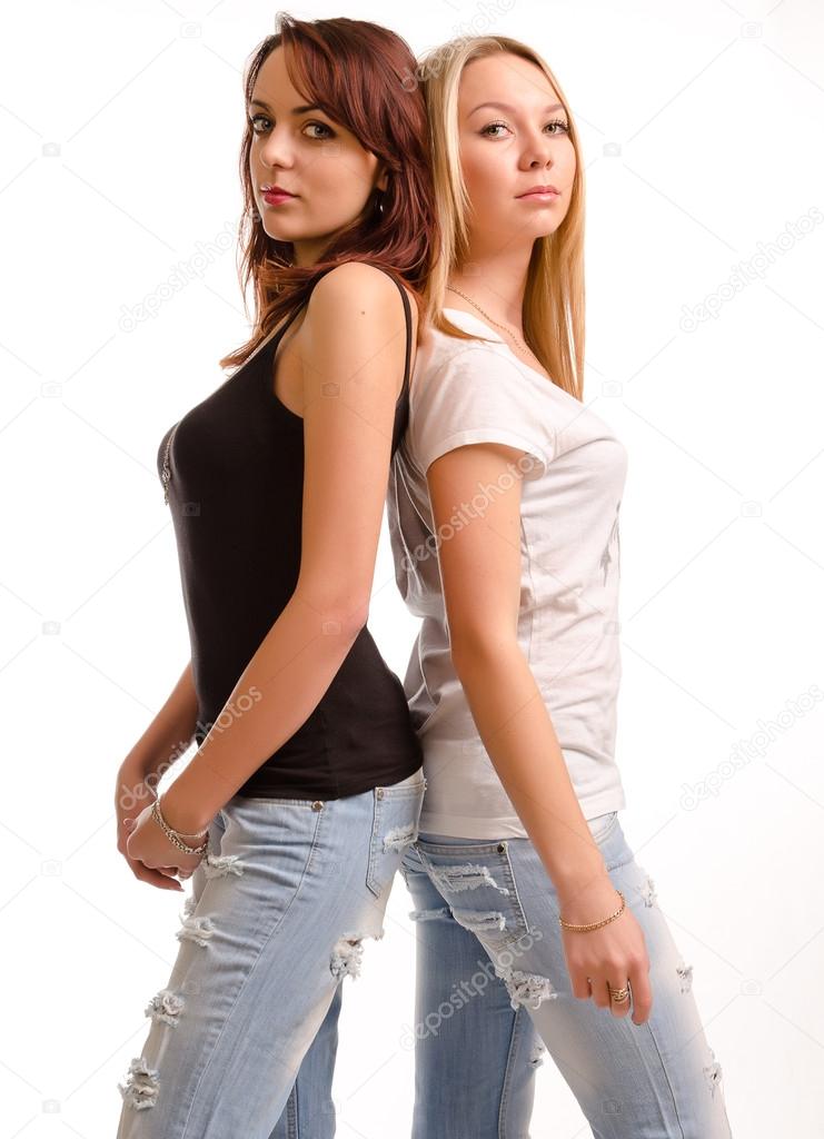 Two curvy young woman standing back to back