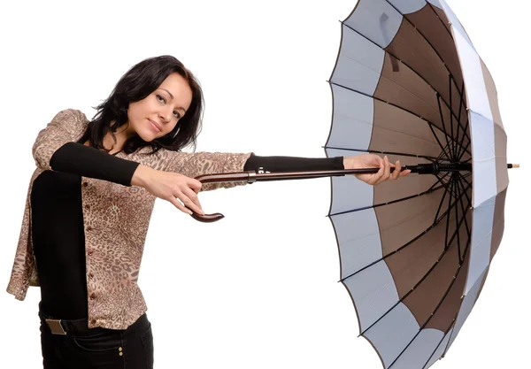 Beautiful brunette woman holding an umbrella — Stock Photo, Image
