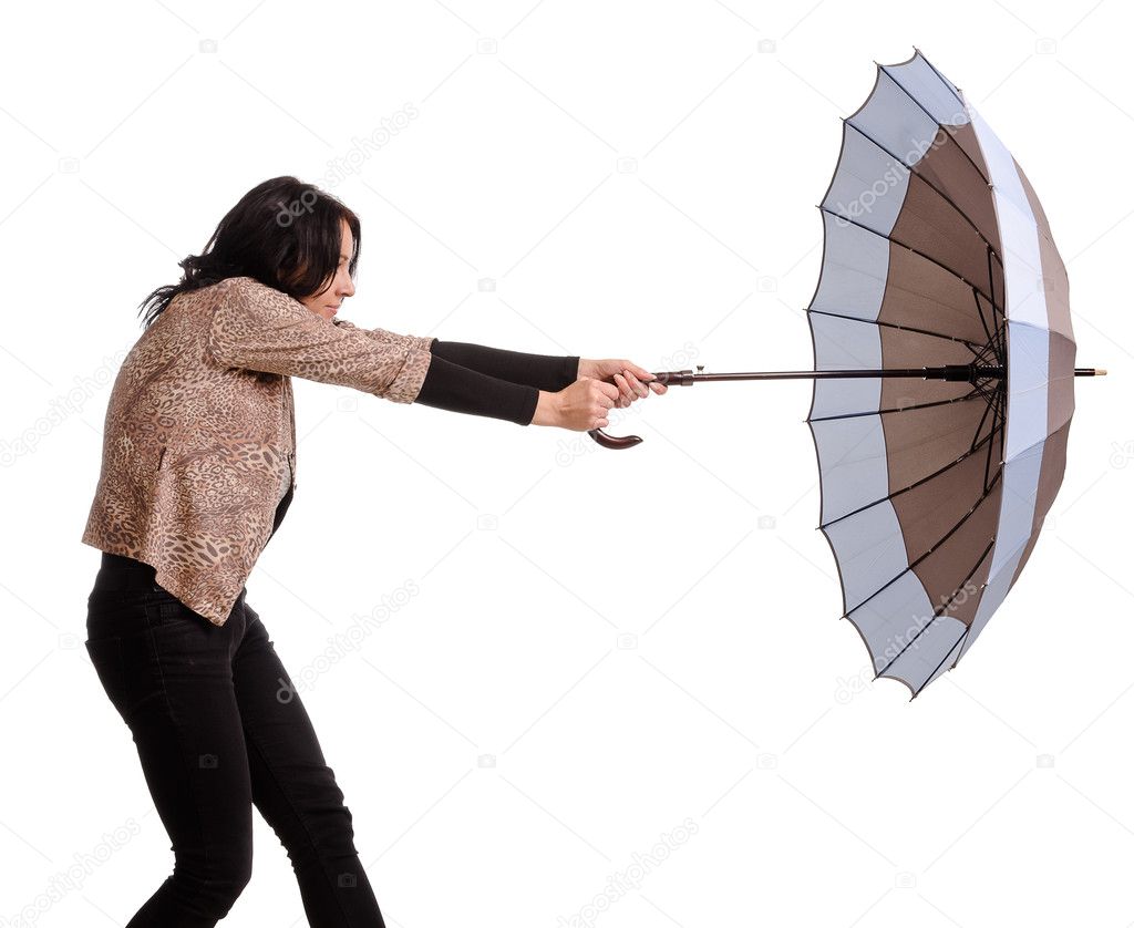 Woman battling with her umbrella in wind
