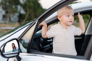 Little boy in an open car door