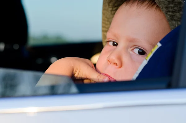 Bored little boy in a car — Stok fotoğraf