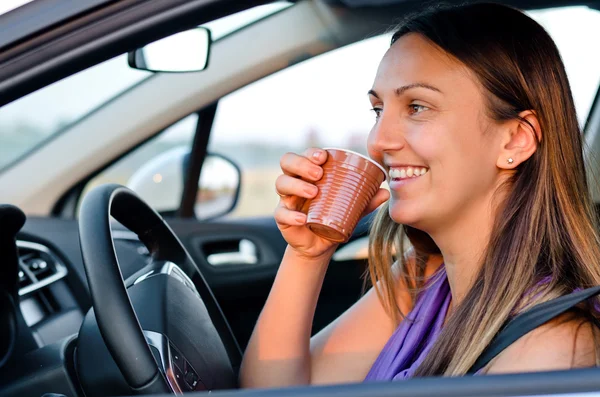 Happy woman enjoying a drink while traveling — Stock Photo, Image