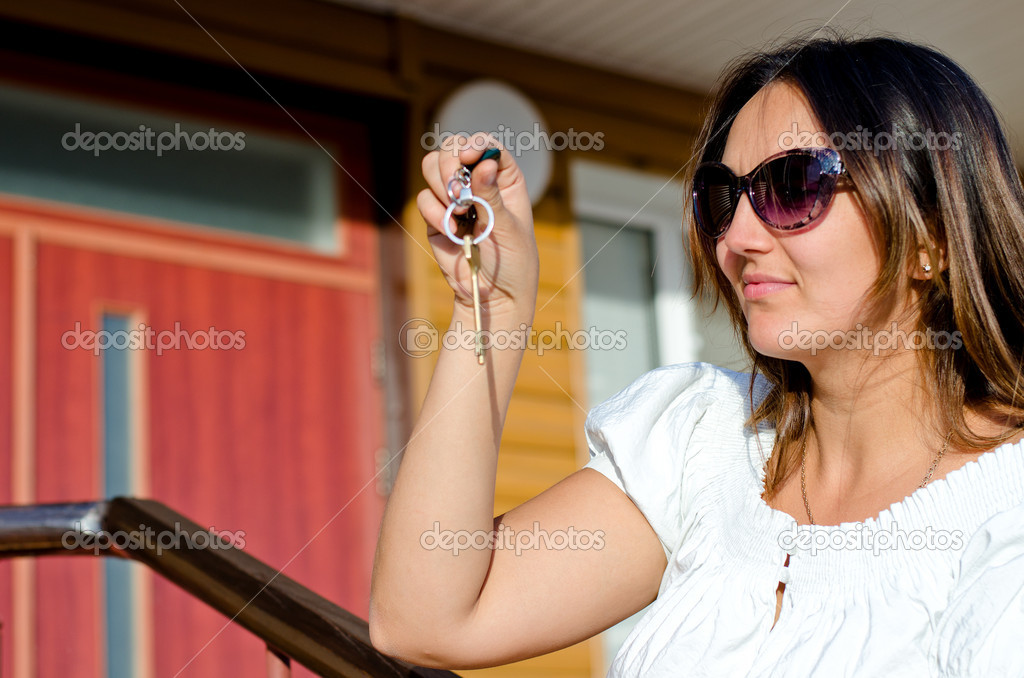 Woman holding the key to a property