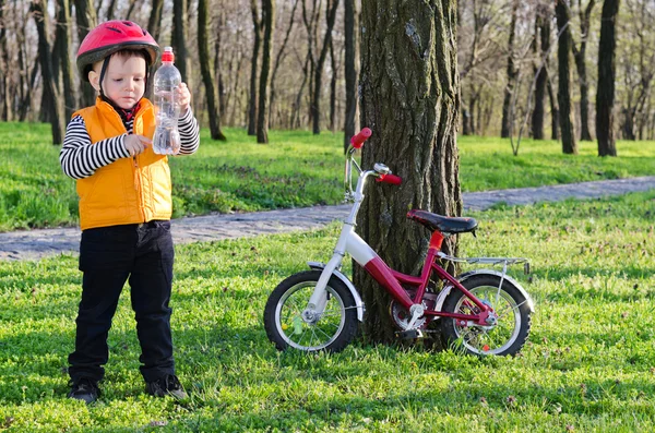 Young rider checking his bottled water — Stock Photo, Image