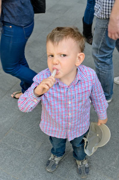 Jonge knappe jongetje eten een traktatie — Stockfoto