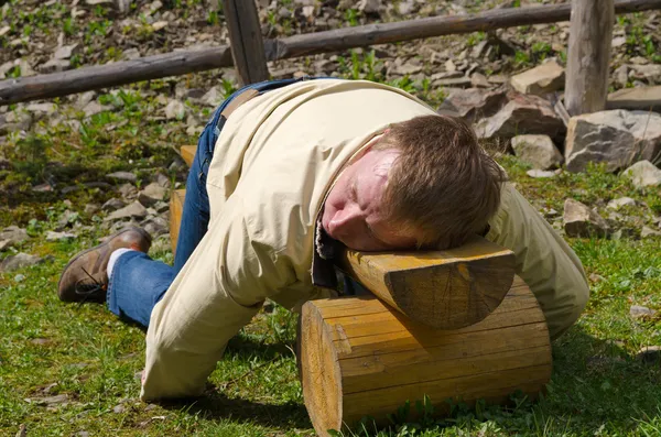 Muž spí na dřevěnou lavici — Stock fotografie