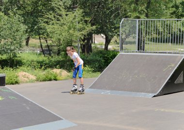 Teenage girl skating in a skate park