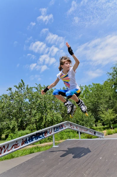 Agile jong meisje rolschaatsen — Stockfoto