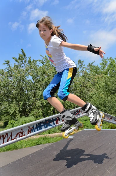 Agile young girl roller skating — Stock Photo, Image