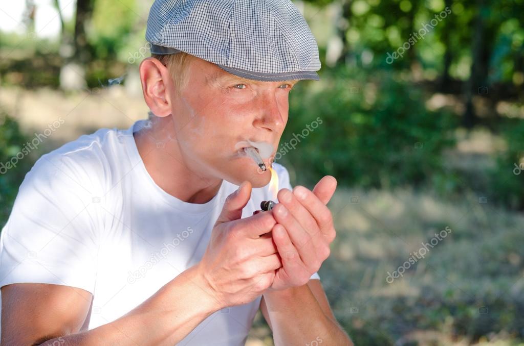 Man lighting up a home made cigarette