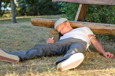 Addicted man fallen down on the ground clipart