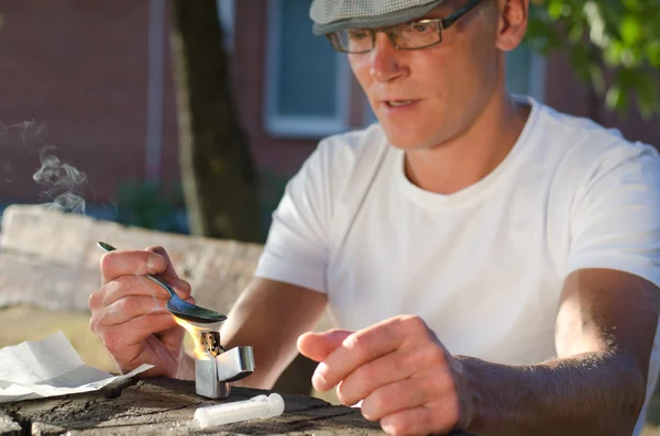 Portrait of an addicted man disolving heroin — Stock Photo, Image