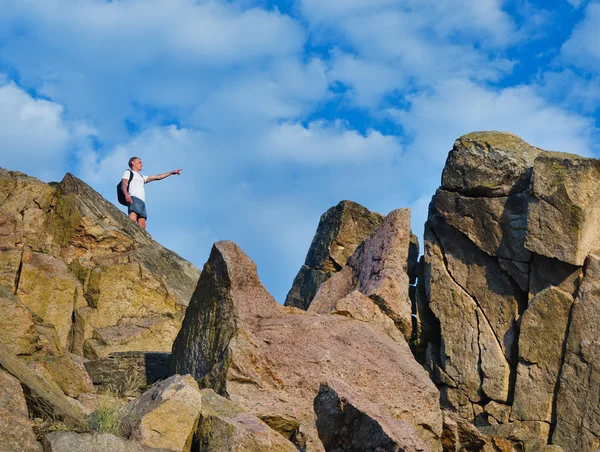 Man op de top van een klif rotsachtige berg — Stockfoto