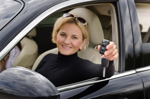 Proud woman driver holding up her car keys — Stock Photo, Image