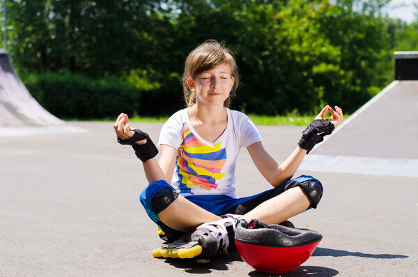 Pretty young teenager sitting meditating