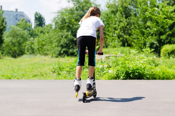 Девочка-подросток играет на скутере — стоковое фото