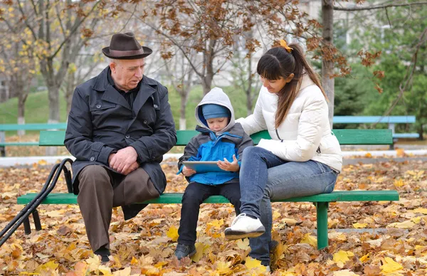 Young boy with his mother and grandfather — Stock Photo, Image