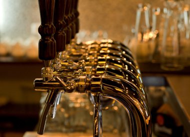 Row of beer taps in a pub or bar clipart