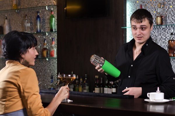 Young woman having a drink at the bar