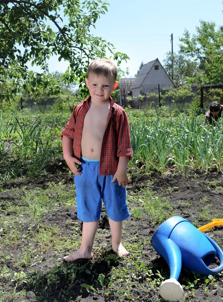 Happy little boy working in the garden — Stock Photo, Image