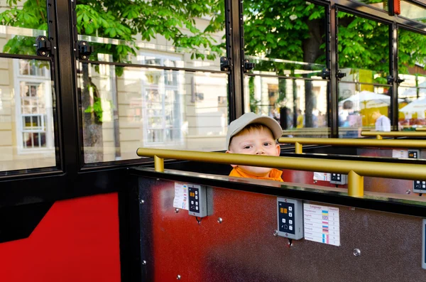 Cute little boy riding in a bus or tram — Stock Photo, Image