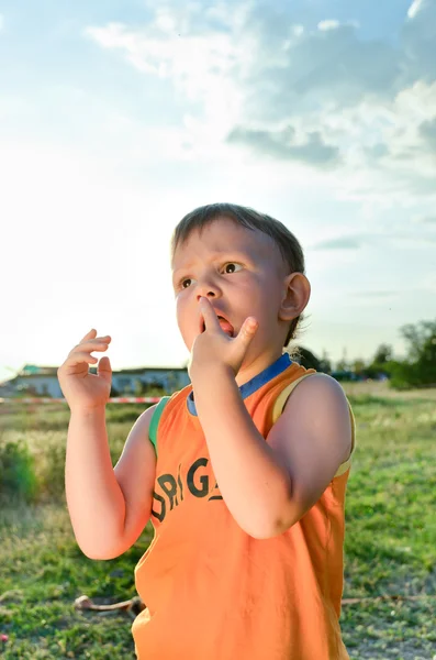 Young boy eating a stick of cotton candy — Stock Photo, Image