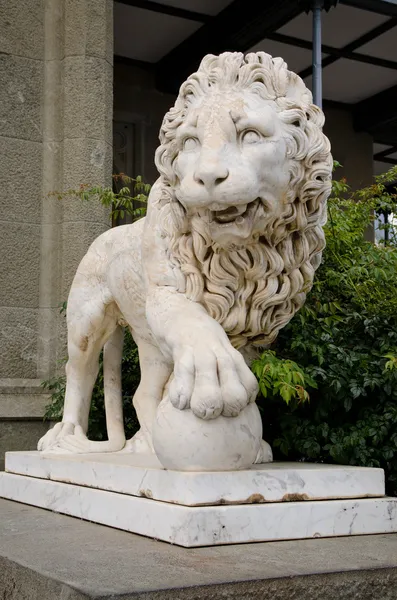 Lion statue with his paw on a sphere