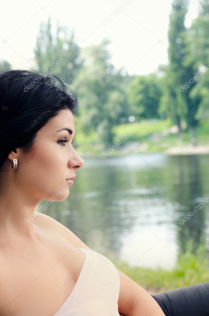 Sophisticated young woman overlooking a lake