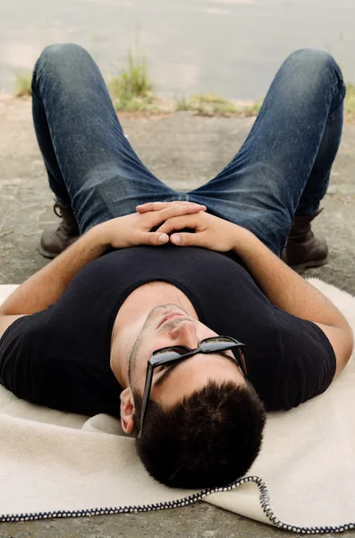 Handsome young man relaxing in the sun — Stock Photo, Image