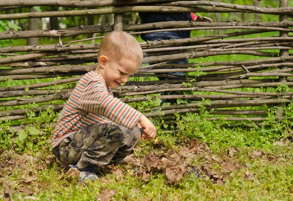 Little boy starting a fire outdoors — Stock Image Little boy starting a fire outdoors Stock Image