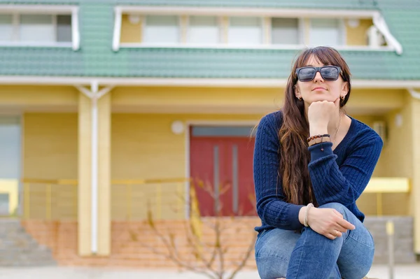 Middle-aged woman sitting thinking outdoors — Stock Photo, Image