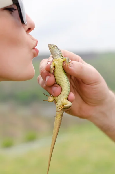 Young woman kissing a lizard — Stock Photo, Image