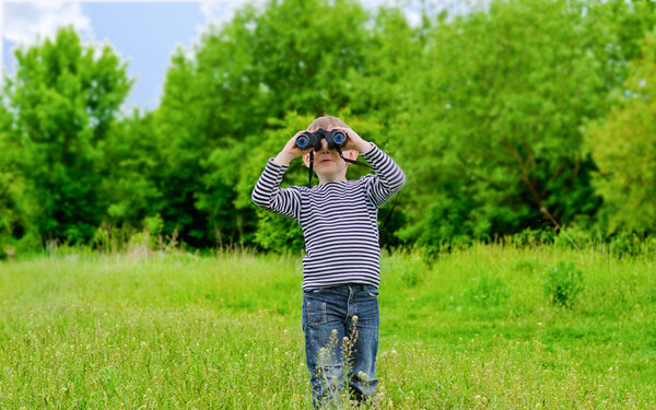 Young kid playing with binoculars