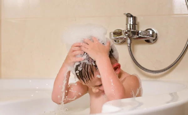 Boy with bubbles on his head — Stock Photo, Image