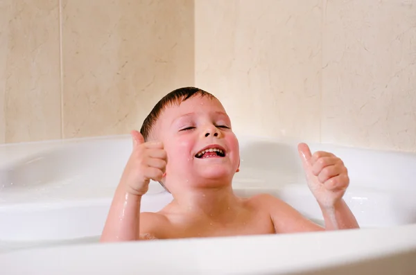 Cute little boy playing in the bath — Stock Photo, Image