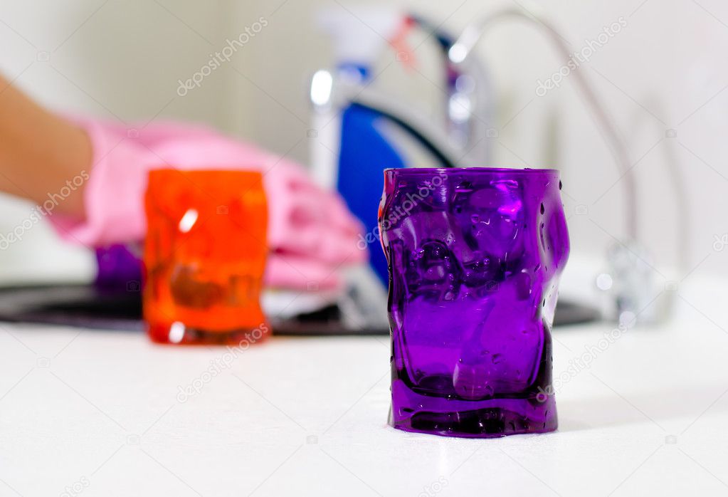 Woman wiping the kitchen counter top