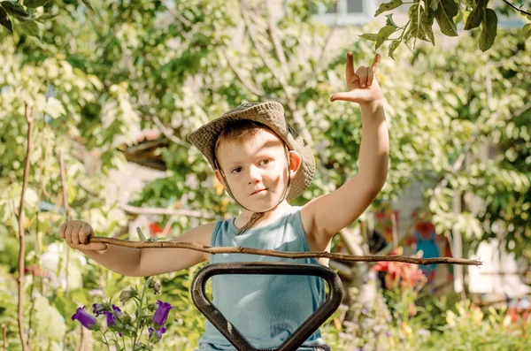 Young boy playing with a stick and gesturing — Stock Photo, Image