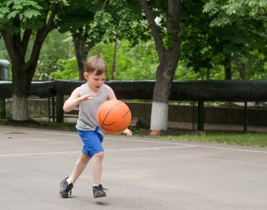 Young boy playing basketball clipart