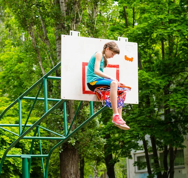 Young girl sitting in hoop — Stock Photo, Image