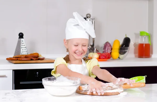 Smiling little girl in a chefs uniform — Stock Photo, Image