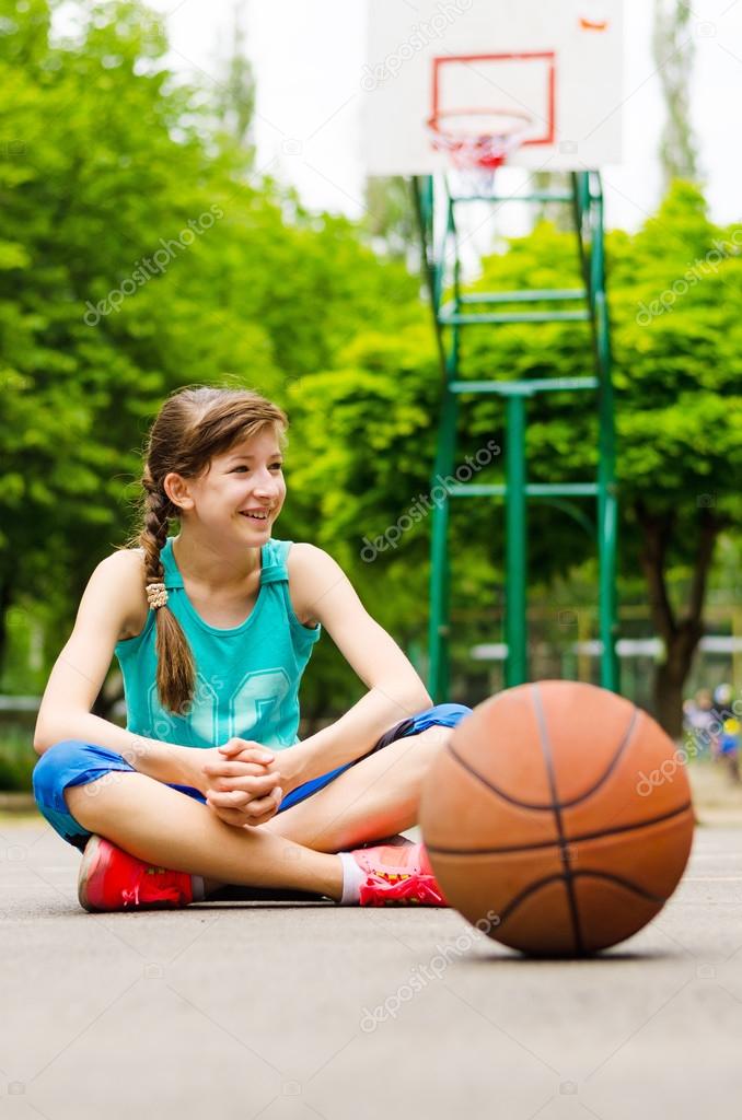 Beautiful confident young female basketball player