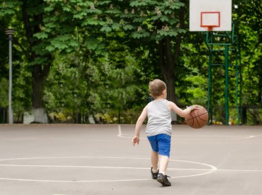 Young boy playing basketball clipart