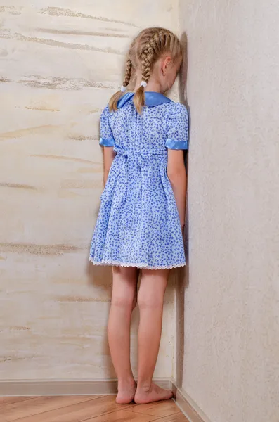 Little girl standing in the corner facing the wall — Stock Photo, Image