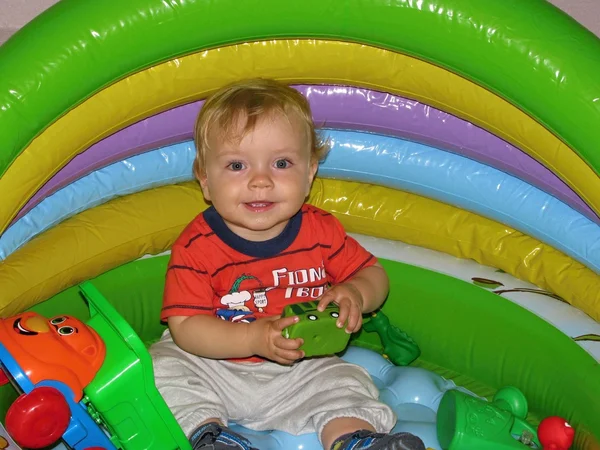 Bebê sentado em uma piscina inflável — Fotografia de Stock